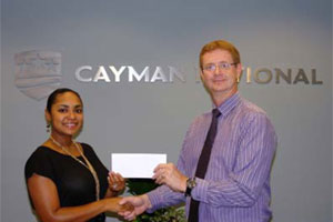 Ana Casildo, Administrative Assistant, CNC Executive Offices presents a cheque to Simon Garnett, Leadership Cayman Chair 2011-2012